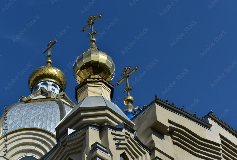 Domes of the temple of St. Panteleimon in Russia, against the blue sky