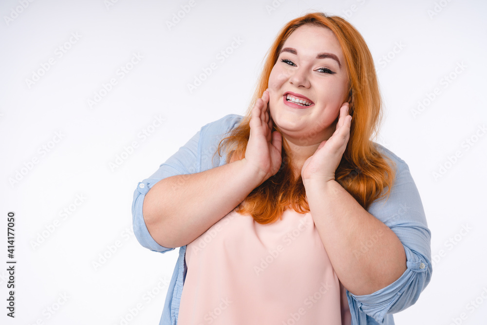 Touched by a compliment plus size redhead woman isolated over white Touched by a compliment plus size redhead woman isolated over white