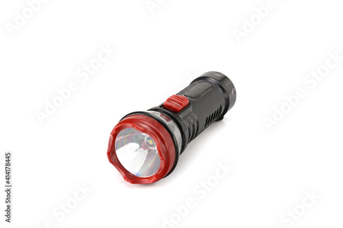 black rechargeable electric LED flashlight isolated on white background. photo