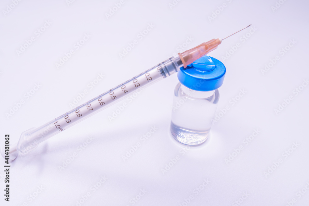 Vaccine and syringe injection. prevention,immunization and treatment from corona virus infection. Vaccine vial dose flu shot drug needle syringe. Vaccine and syringe injection. prevention,immunization and treatment from corona virus infection. Vaccine vial dose flu shot drug needle syringe.