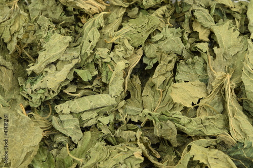 Dried nettle leaves, herbs for tea as background © Anna