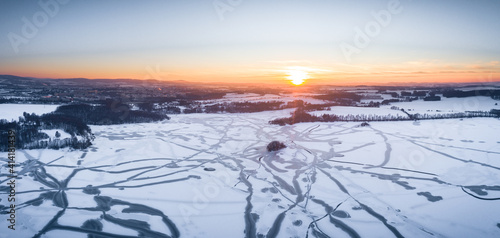 Drone shot above the Dam reservoir in Bautzen during sunset with frozen lake winter season ice snow photo