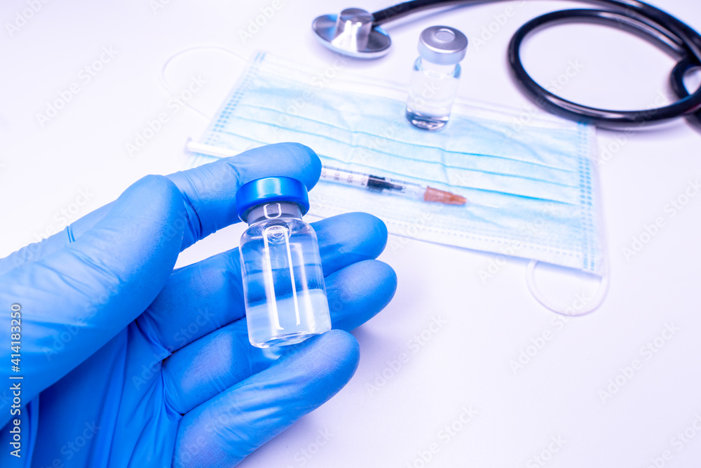 Medical banner with doctor hands in rubber gloves holding vial with vaccine. Vaccination concept. World Diabetes Day concept. Copy space for your design. Covid 19. Coronavirus Medical banner with doctor hands in rubber gloves holding vial with vaccine. Vaccination concept. World Diabetes Day concept. Copy space for your design. Covid 19. Coronavirus