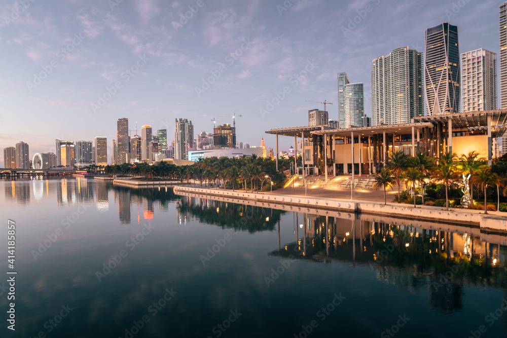 Miami florida city beautiful view panorama downtown buildings skyscrapers park reflections trees palms water sea lights sunrise 