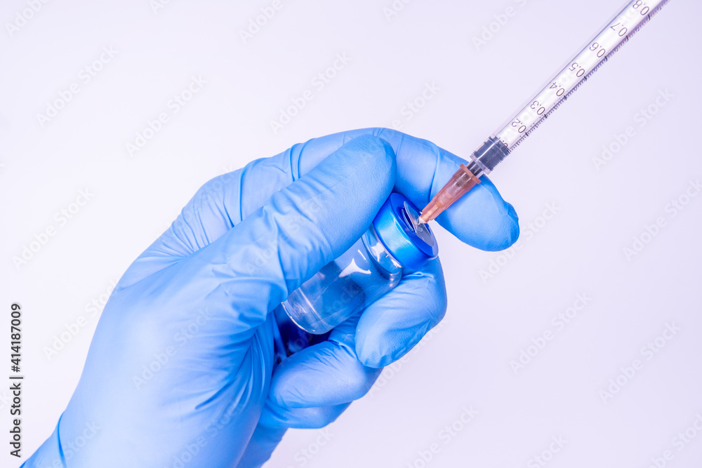 Syringe in a hand of a doctor or nurse and medicine or vaccine vial. Vaccination and immunization concept. Medicine and health care. Vaccine trials and research. Pharmacy. COpy space Syringe in a hand of a doctor or nurse and medicine or vaccine vial. Vaccination and immunization concept. Medicine and health care. Vaccine trials and research. Pharmacy. COpy space
