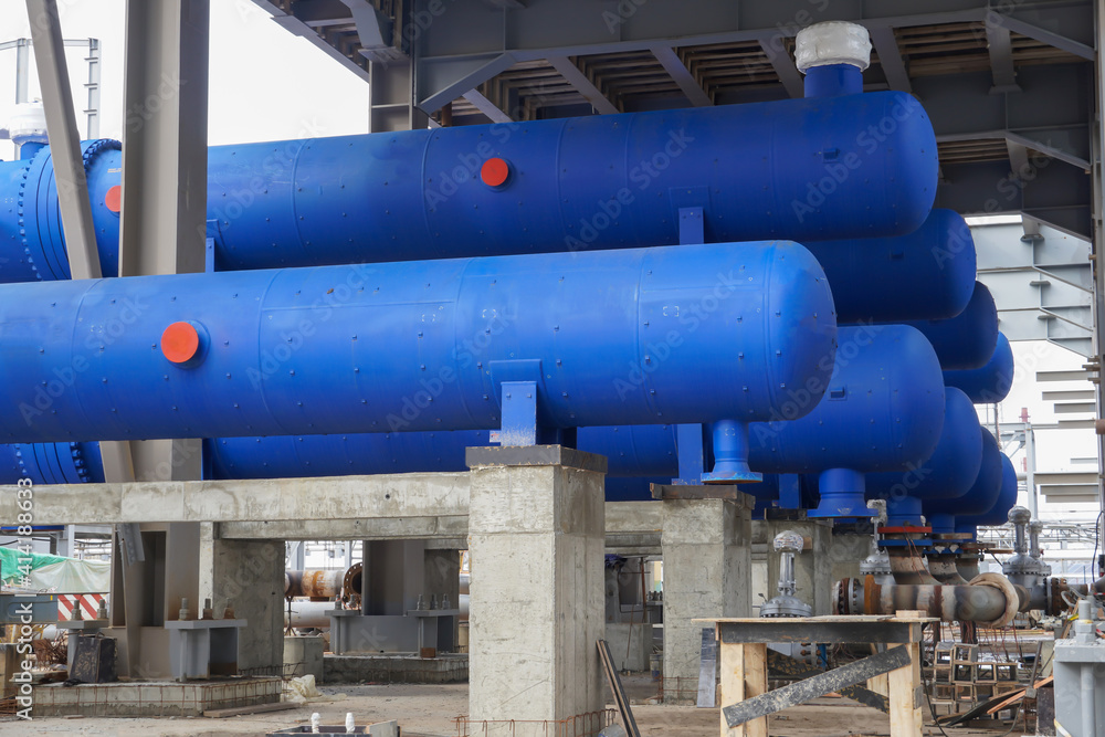 Block of blue heat exchangers and pipelines for the construction of an oil refinery complex at a plant in Russia. Block of blue heat exchangers and pipelines for the construction of an oil refinery complex at a plant in Russia.