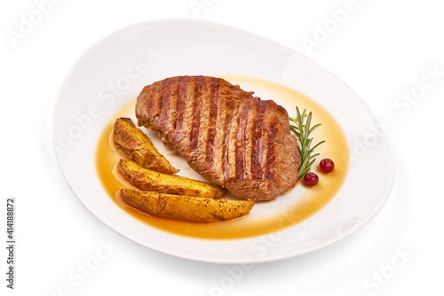 Grilled beef steak with potato wedges, isolated on white background