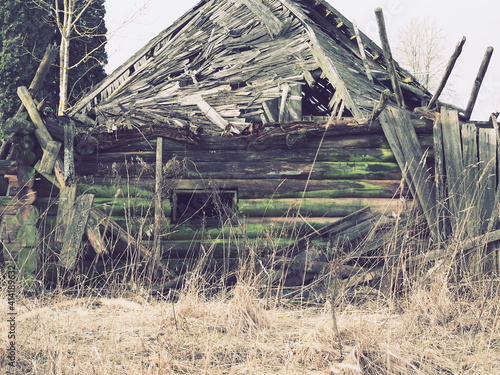 Collapsed log house. Abandoned country house. Collapsed roof