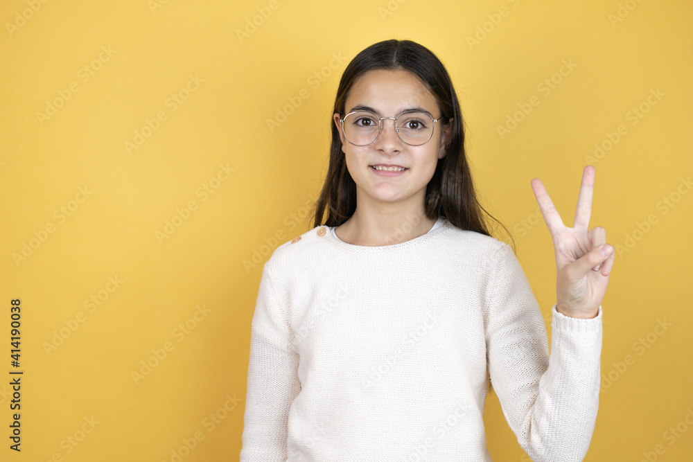 Beautiful child girl wearing casual clothes showing and pointing up with fingers number two while smiling confident and happy Beautiful child girl wearing casual clothes showing and pointing up with fingers number two while smiling confident and happy