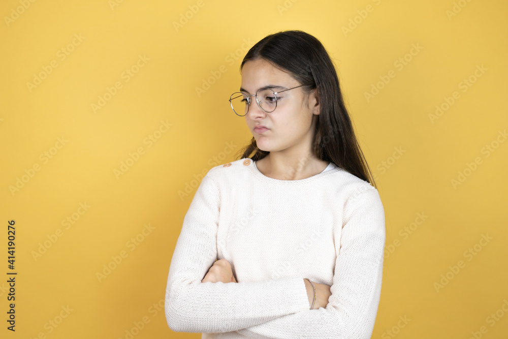 Beautiful child girl wearing casual clothes thinking looking tired and bored with crossed arms Beautiful child girl wearing casual clothes thinking looking tired and bored with crossed arms