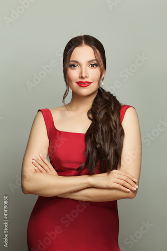 Fashion model woman in red dress standing on white background