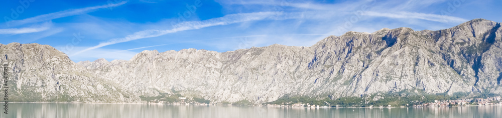 Panoramic view of Bay of Kotor from the sea surrounded by mountains in Montenegro, one of the most beautiful bay in the world