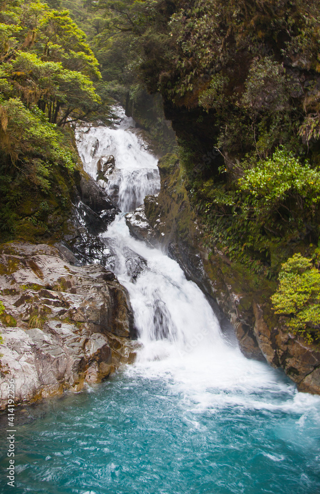 Waterfall flowing down mountain in New Zealand. Waterfall flowing down mountain in New Zealand.