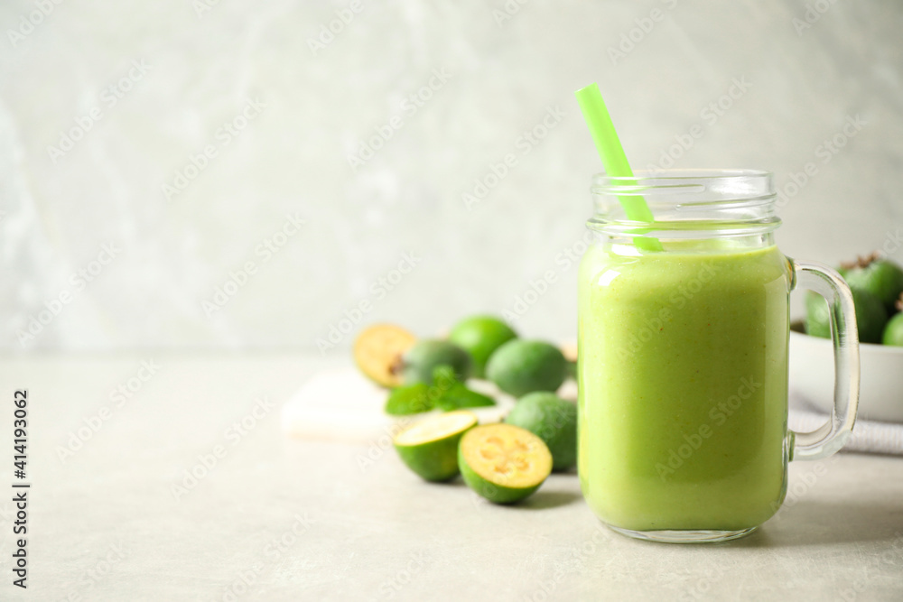 Fresh feijoa smoothie in mason jar on light table, closeup. Space for text Fresh feijoa smoothie in mason jar on light table, closeup. Space for text
