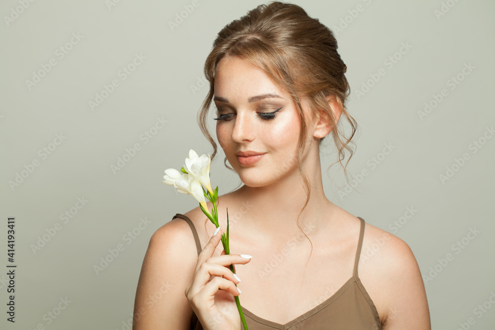 Perfect young woman with healthy skin holding white flowers, skincare and facial treatment concept Perfect young woman with healthy skin holding white flowers, skincare and facial treatment concept