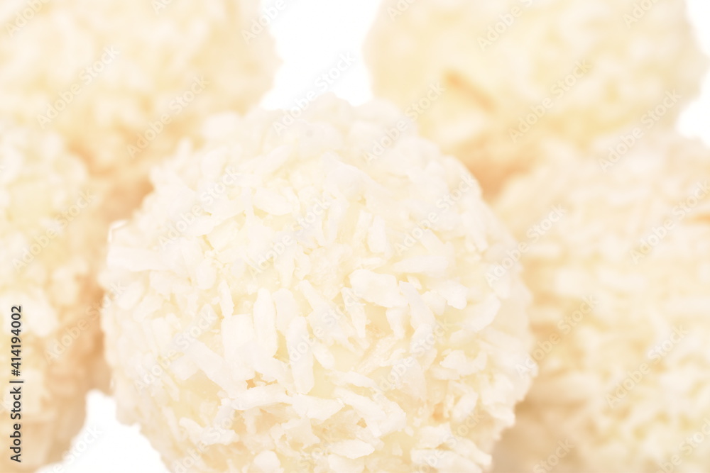 Several round sweets with coconut flakes, close-up, isolated on white. Several round sweets with coconut flakes, close-up, isolated on white.