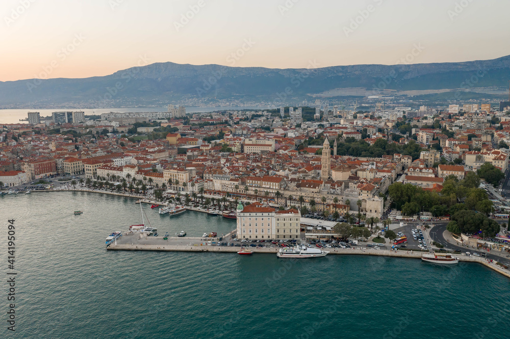 Aerial drone shot of Diocletian Palace by riva in Split old town after sunset in Croatia