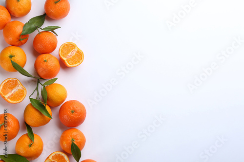 Fresh ripe tangerines with green leaves on white background, top view © New Africa