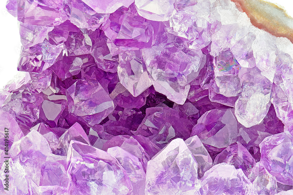 Amazing rare shape sparkly Violet Crystal Stone macro mineral surface. Purple rough Amethyst quartz Crystals geode on white background. Amethyst looks like a cave made of stone. Amazing rare shape sparkly Violet Crystal Stone macro mineral surface. Purple rough Amethyst quartz Crystals geode on white background. Amethyst looks like a cave made of stone.
