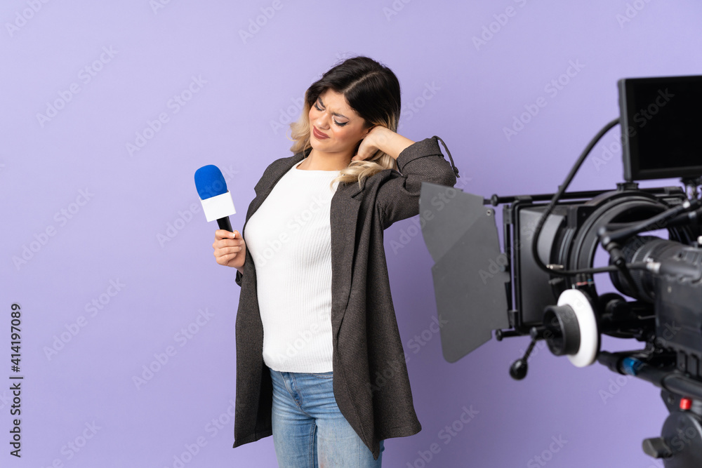 Reporter teenager girl holding a microphone and reporting news isolated on purple background with neckache Reporter teenager girl holding a microphone and reporting news isolated on purple background with neckache