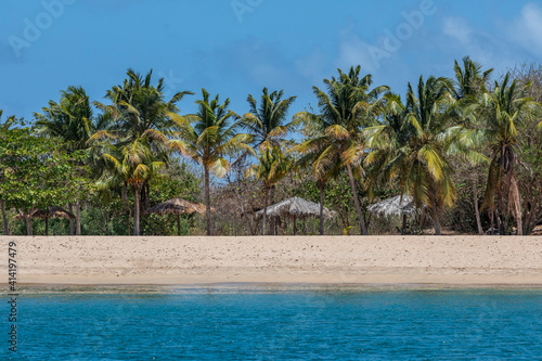 Caribbean  Grenada  Mayreau Island. Thatched roof cabanas and beach.