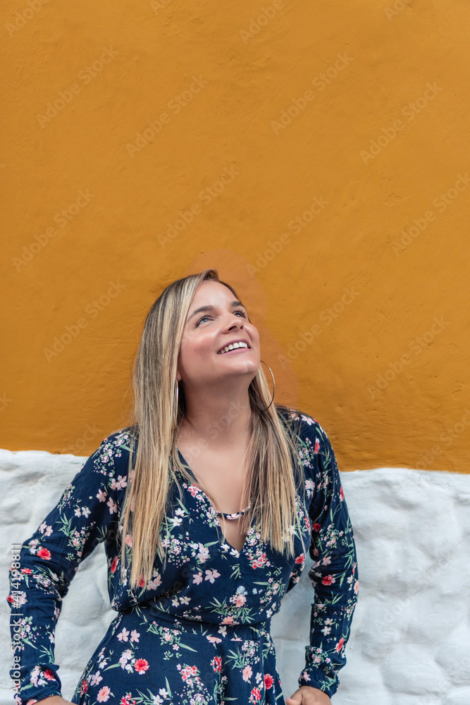 Girl with long hair on the background of yellow and white wall. Urban fashion. Girl with long hair on the background of yellow and white wall. Urban fashion.