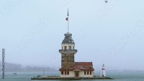 maiden's tower and seagulls under snowfall