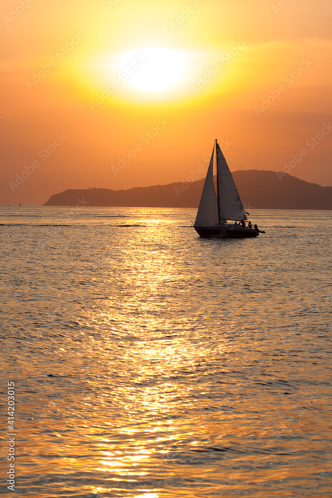 Sailboat sailing during summer sunset