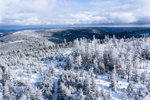 Stunning landscape scenery and view from the summit on snow covered forest.