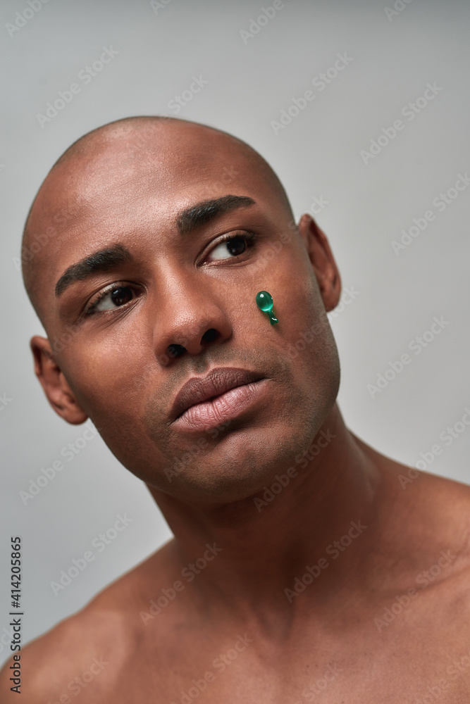 Obraz premium Anti-wrinkles vitamin capsule stuck under person eye