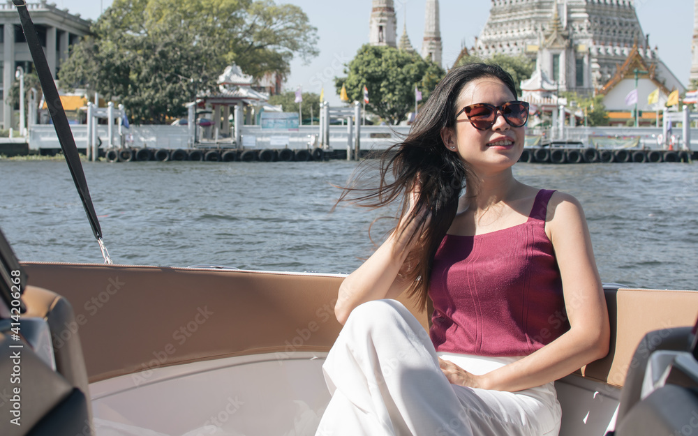 Asian woman sitting on boat with beautiful landscape