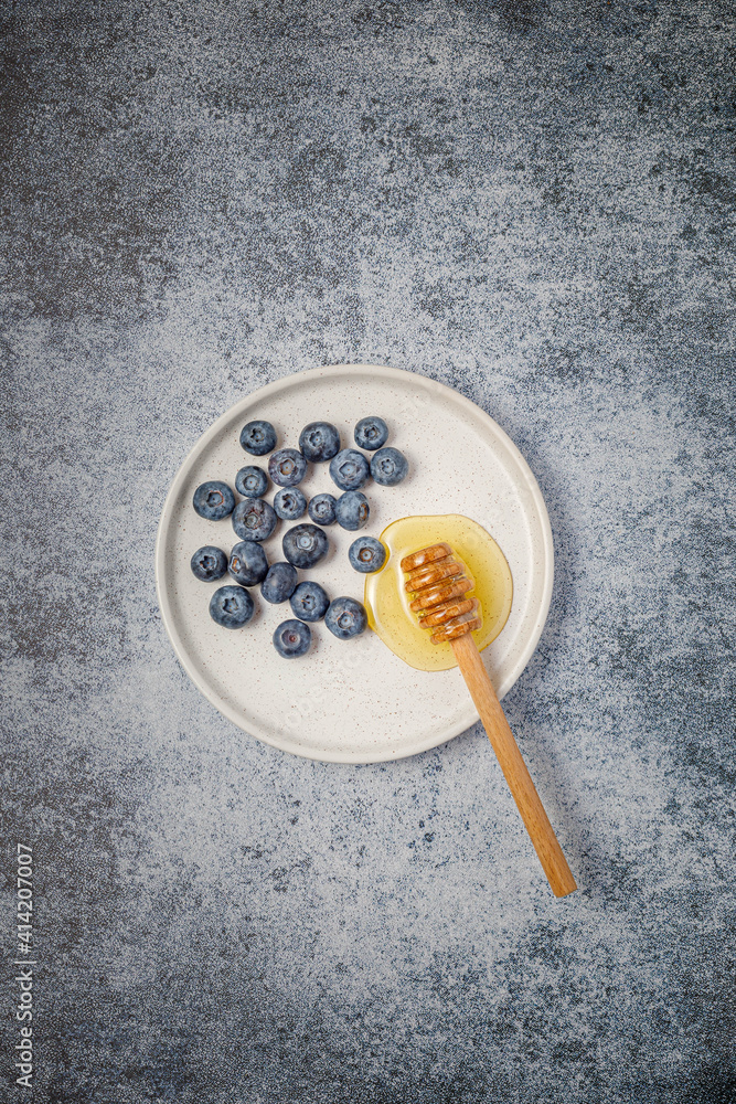 Fresh berries (blueberries and raspberries) with honey Fresh berries (blueberries and raspberries) with honey