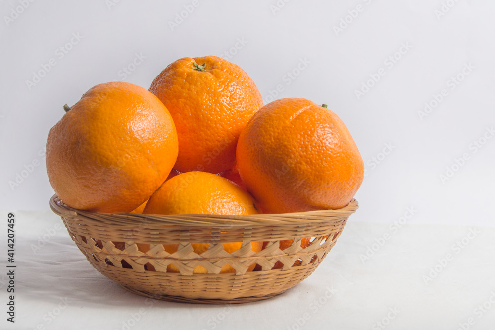 basket with oranges isolated on cloth background basket with oranges isolated on cloth background