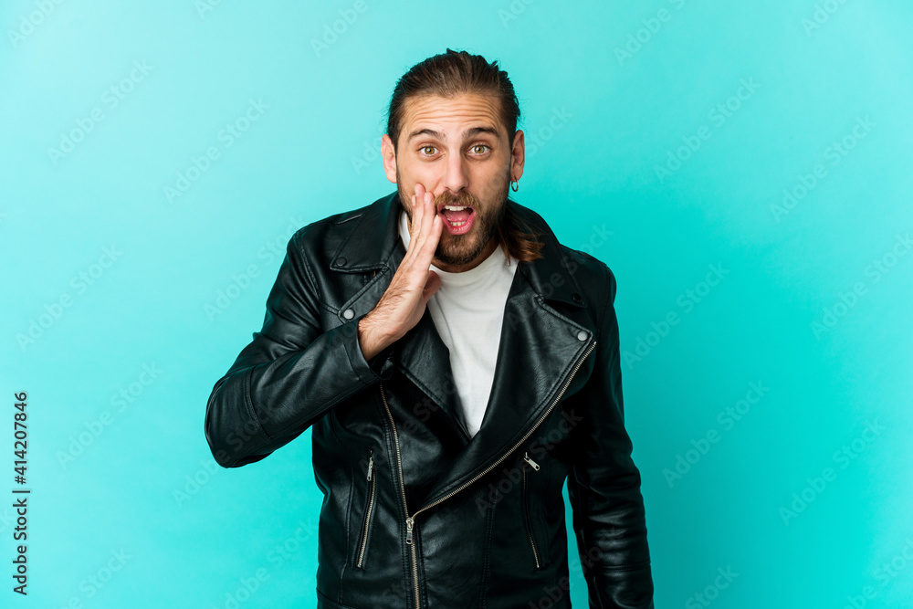 Young man with long hair look shouts loud, keeps eyes opened and hands tense. Young man with long hair look shouts loud, keeps eyes opened and hands tense.