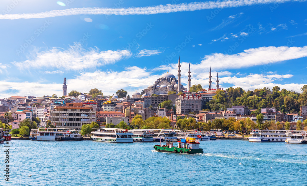 Fototapeta premium Eminonu Pier with Ships and Suleymaniye Mosque on the background, view from the Golden Horn inlet, Istanbul
