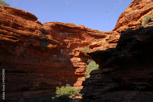 A beautiful red rock canyon seen in shadow and light in the outback of the Northern Territory of Australia.