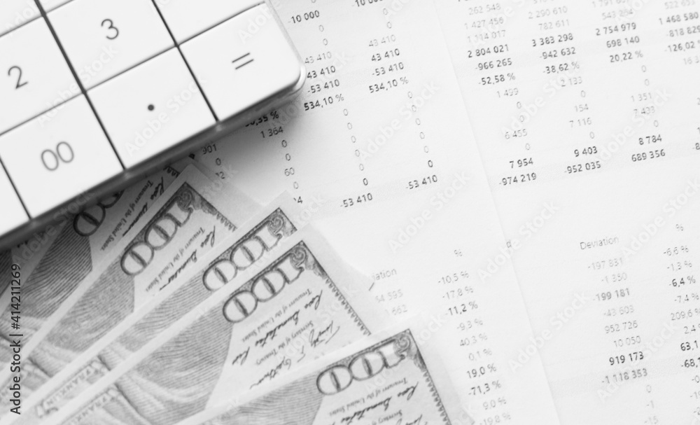 Calculator with money on financial data. Business and financial concept. Calculator with money on financial data. Business and financial concept.
