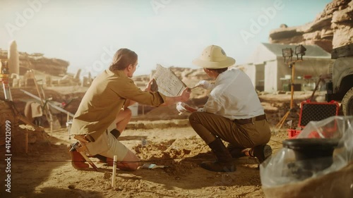 Archeological Digging Site: Two Great Archeologists Work on Excavation Site, Carefully Lifting Newly Discovered Ancient Civilization Cultural Artifact, Historical Clay Tablet, Fossil Remains photo