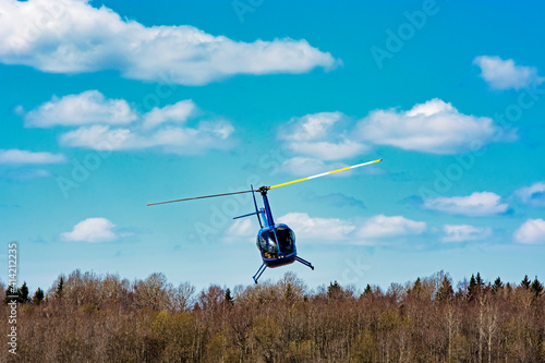 helicopter robinson 44 flies in the sky photo