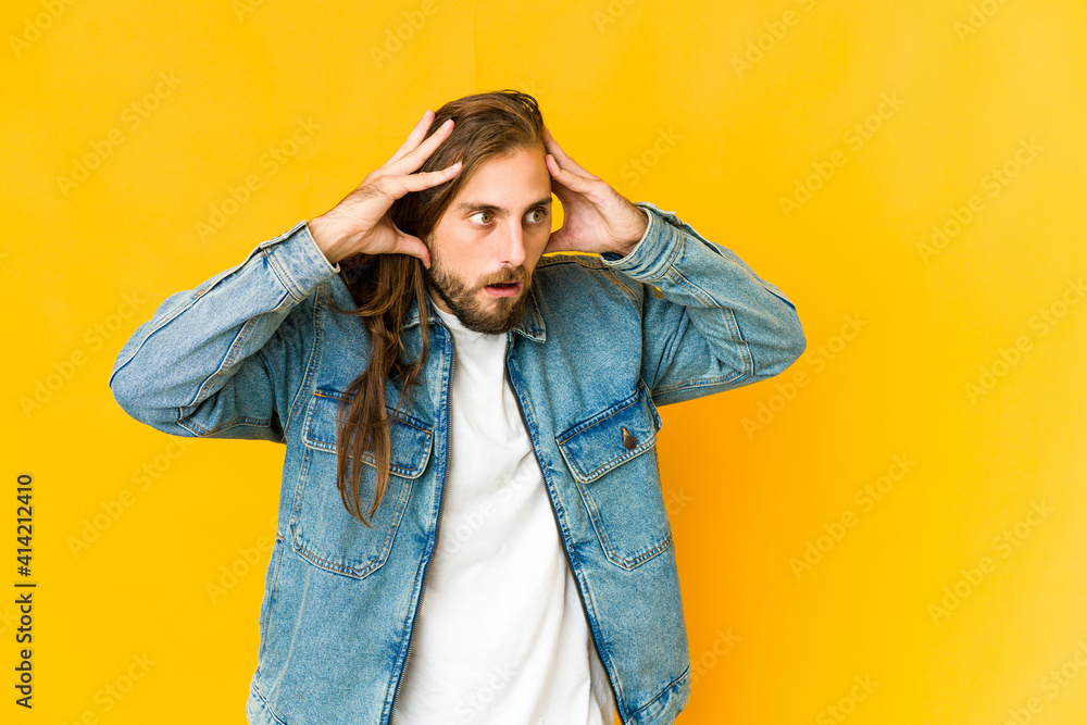 Young man with long hair look screaming, very excited, passionate, satisfied with something. Young man with long hair look screaming, very excited, passionate, satisfied with something.