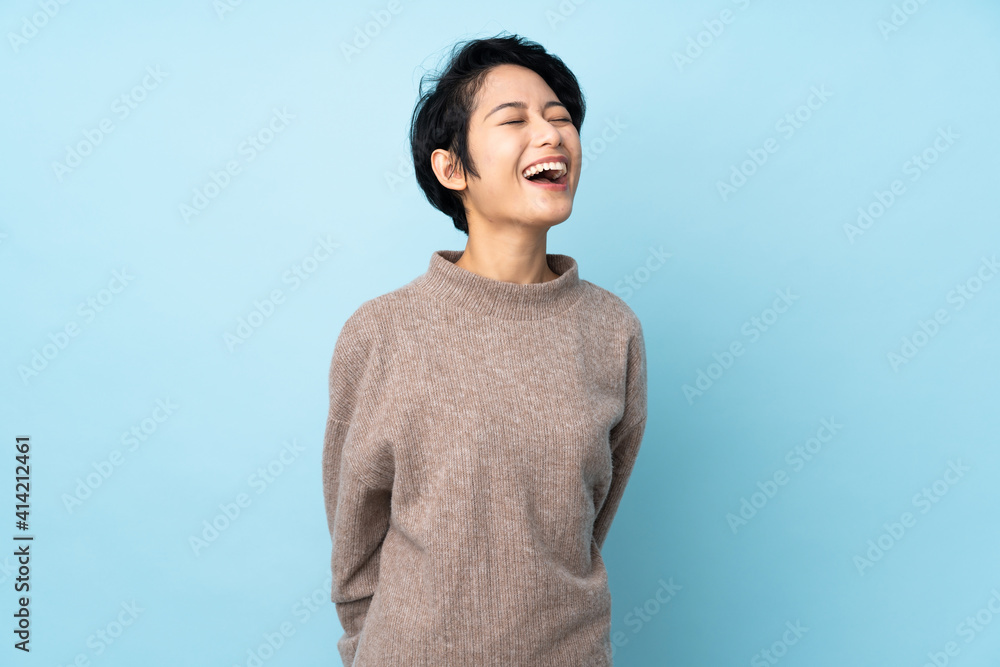 Young Vietnamese woman with short hair over isolated background laughing Young Vietnamese woman with short hair over isolated background laughing