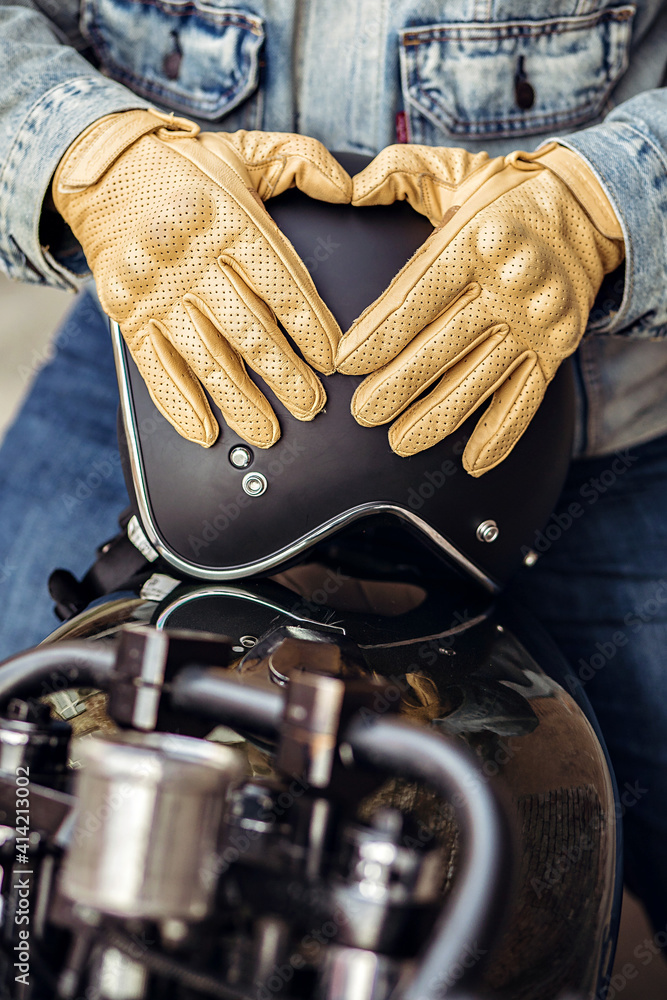 Obraz premium Close up set of an experienced driver. Close up motorcycle detail. Black helmet and yellow gloves of a motorcycle driver. Hipster lifestyle