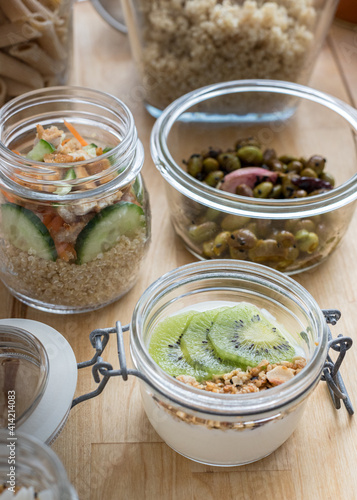 Healthy Homemade meal in glass jars on a wooden table