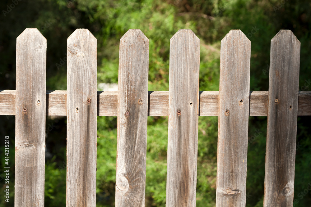 Wooden fence on green background