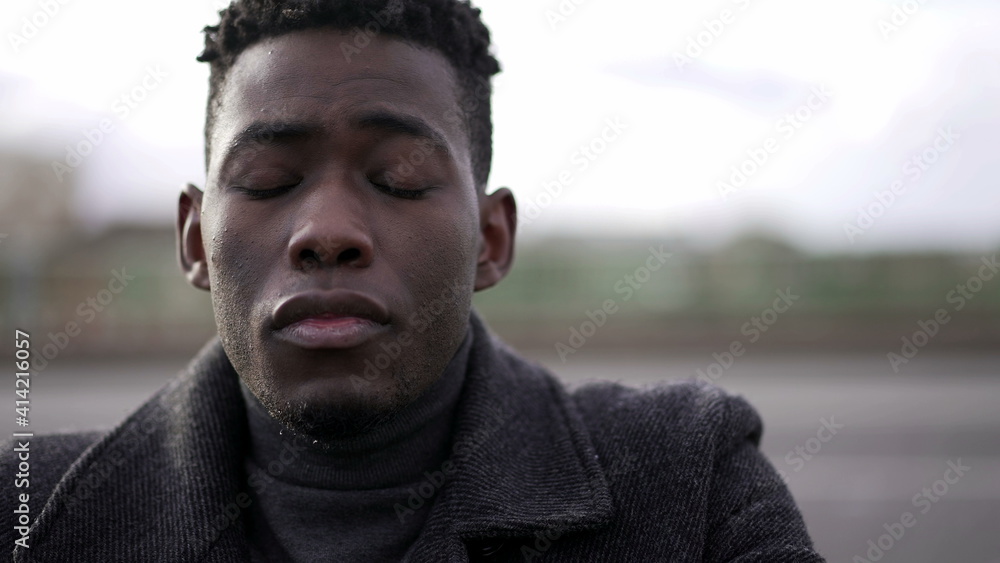 Fototapeta premium Young man preoccupied, black man eyes closed