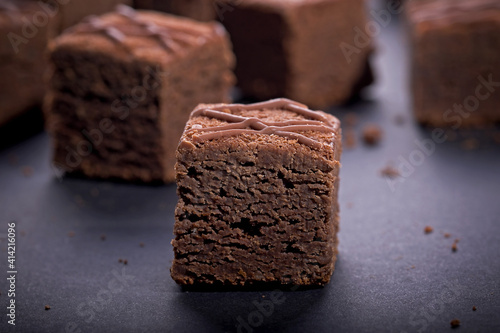 Chocolate brownie cake cubes on a dark background