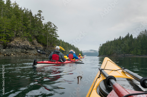 Canada, British Columbia. Sea kayakers paddle through Blackney Passage on an adventure near Johnstone Strait. © Danita Delimont