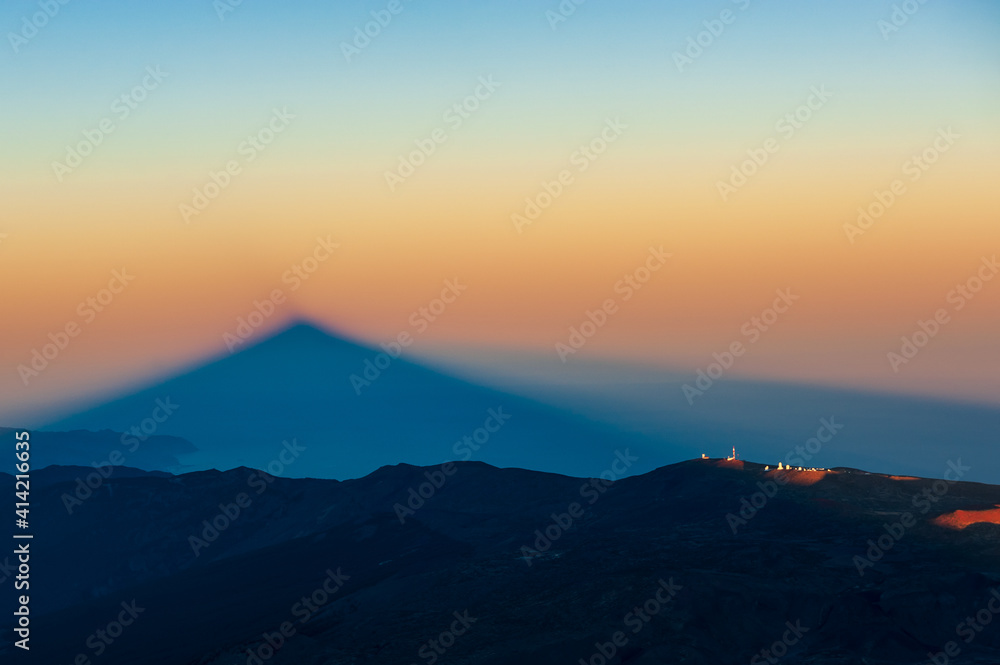 Silhouette of shadow of volcano del Teide  at sunset. Pico del Teide mountain in El Teide National park. Tenerife, Canary Islands, Spain