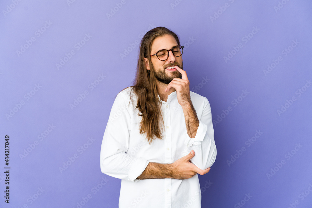Young man with long hair look relaxed thinking about something looking at a copy space. Young man with long hair look relaxed thinking about something looking at a copy space.
