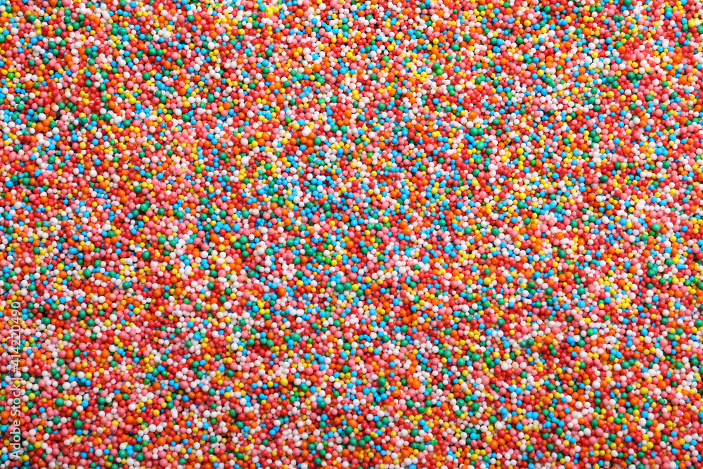 Bright colorful sprinkles as background, top view. Confectionery decor Bright colorful sprinkles as background, top view. Confectionery decor